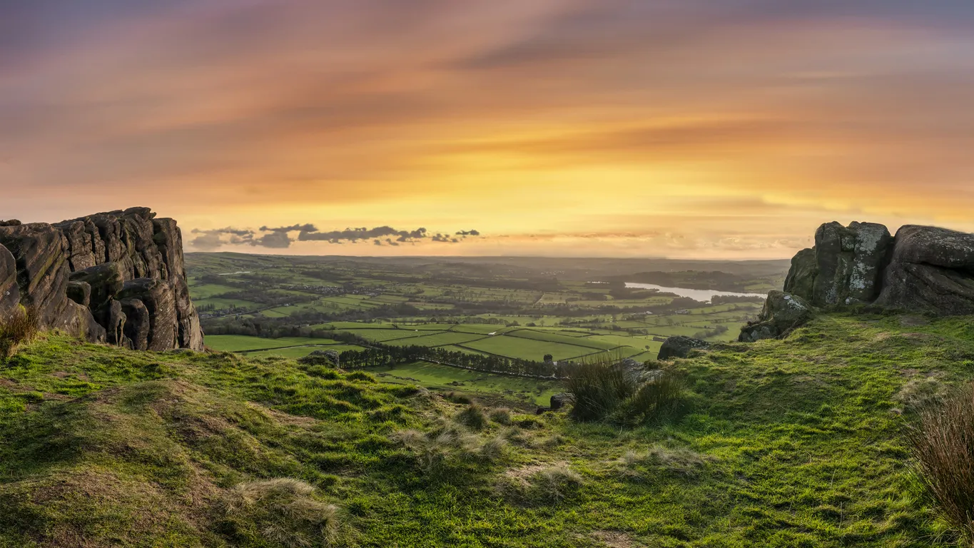 Stunning Peak District Winter landscape of view from top of Hen Cloud over countryside and towards Tittesworth Reservoir
