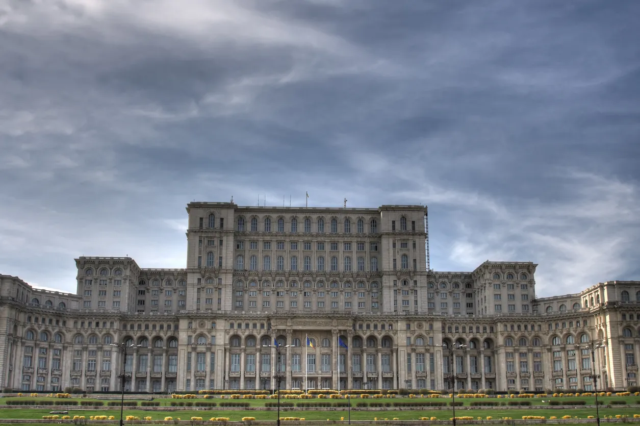 The giant white Parliament Palace in Bucharest, Romania with cloudy skies