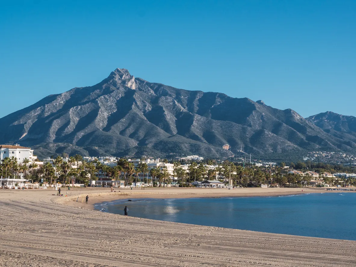 Beach of Puerto Banus with the mountains of Sierra Blanca at background, Marbella, Costa del Sol, Malaga province, Spain