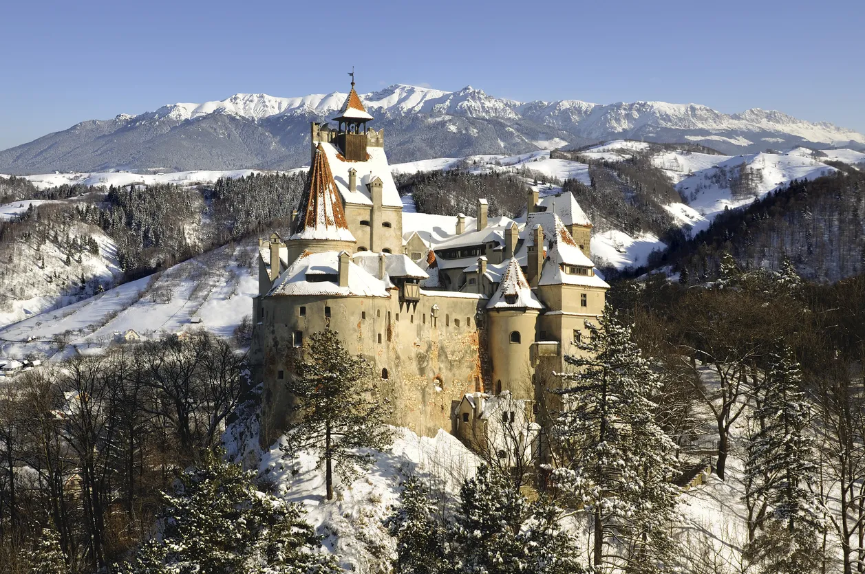Bran Castle in winter with snow and Bucegi mountains.More pictures with Dracula