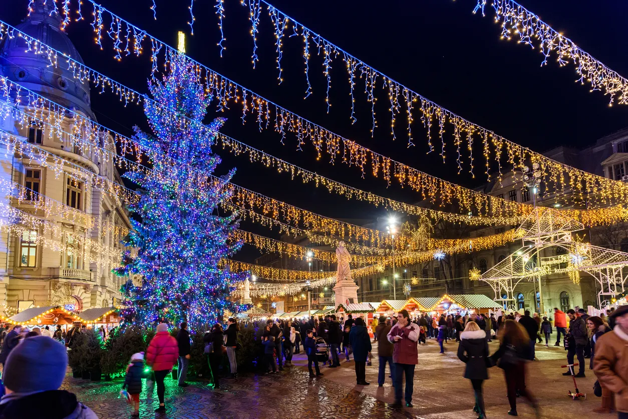 Bucharest, Romania - December 23, 2015:  People Gather At The Christmas Market Downtown Bucharest City At Night In The University Square.