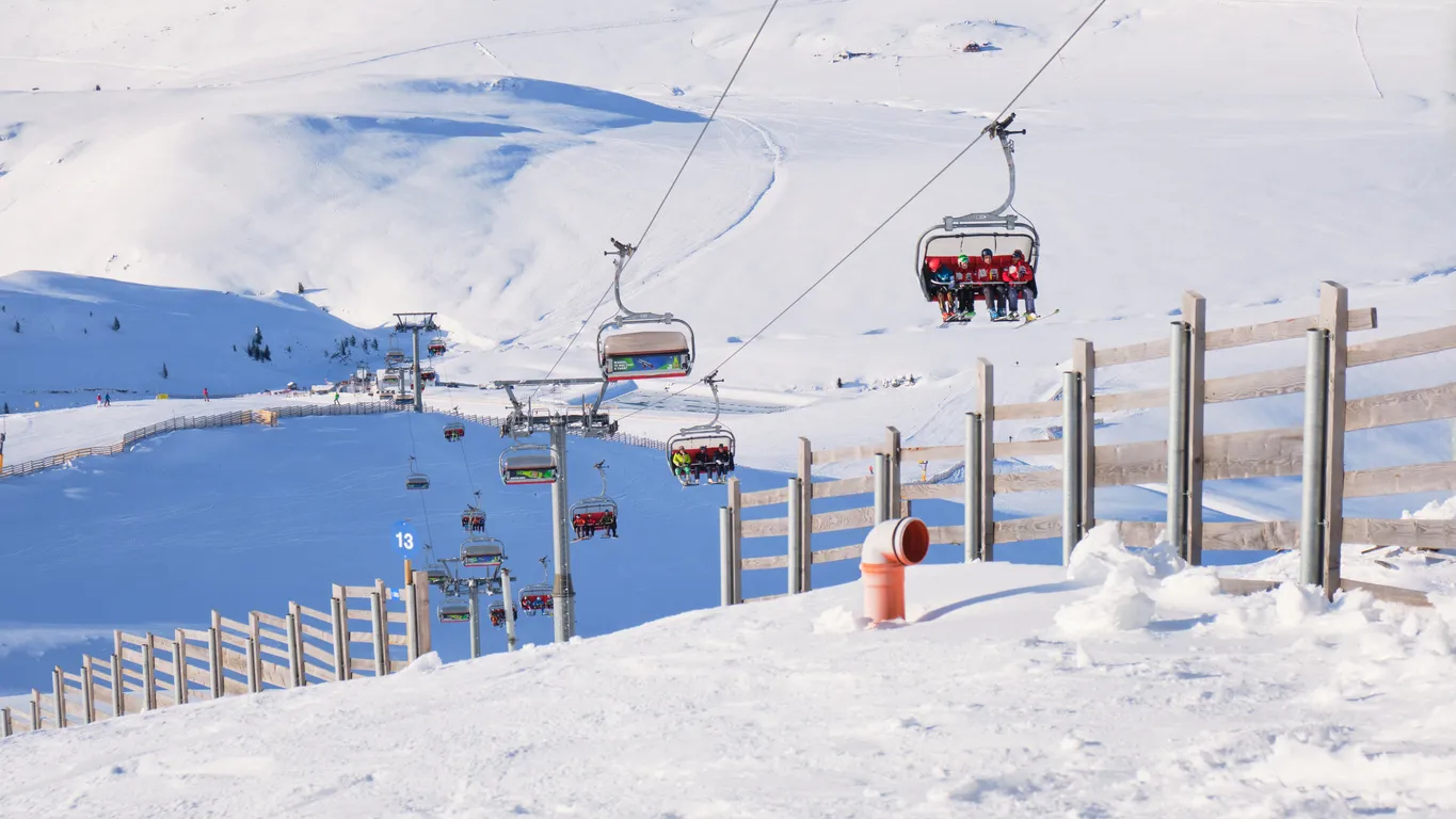Sinaia, Romania - December 16, 2019: Chairlift and wooden fence at Cota 2000, Sinaia ski domain, Romania, on a sunny Winter day.