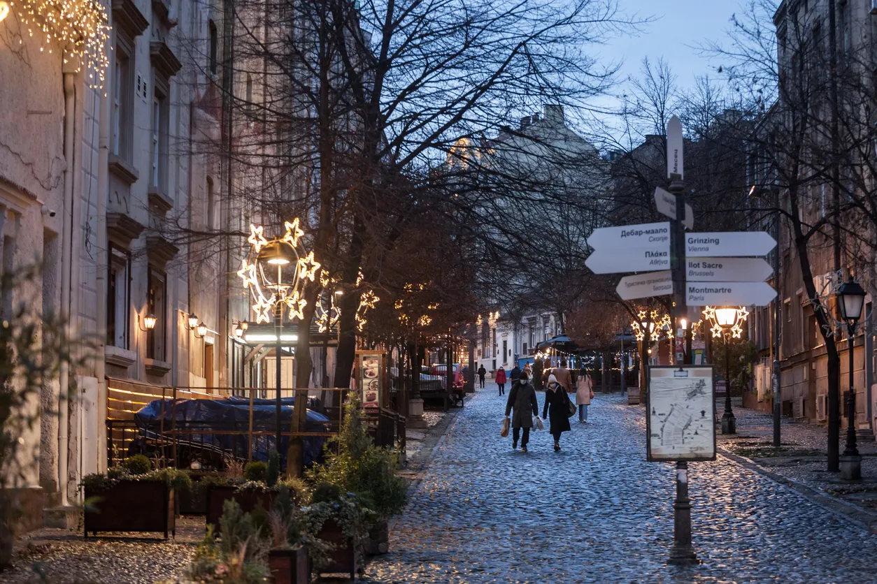 Picture of white caucasian people in belgrade, serbia, walking in the streets of Belgrade, capital city of Serbia, while wearing a respiratory face mask during the coronavirus health crisis.
