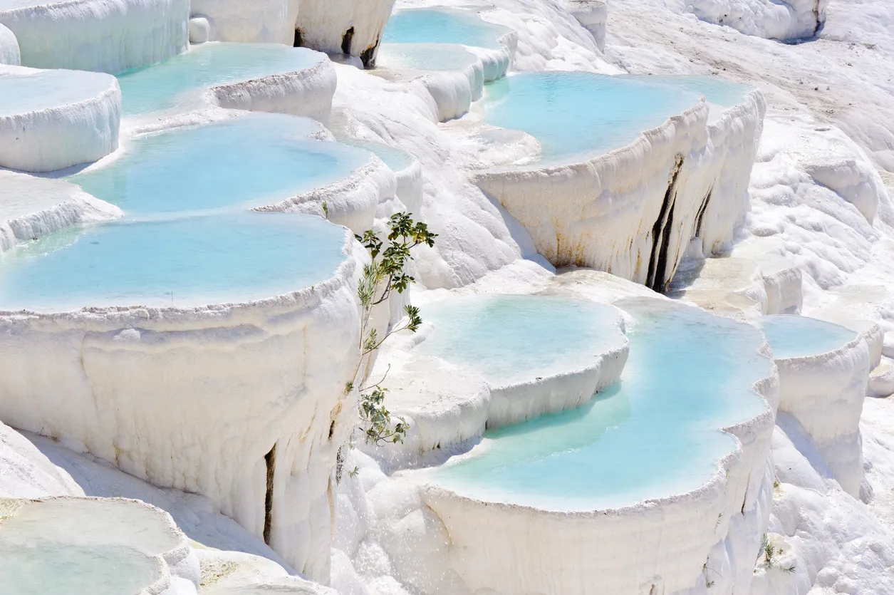 Blue cyan water travertine pools at ancient, now Pamukkale, Turkey