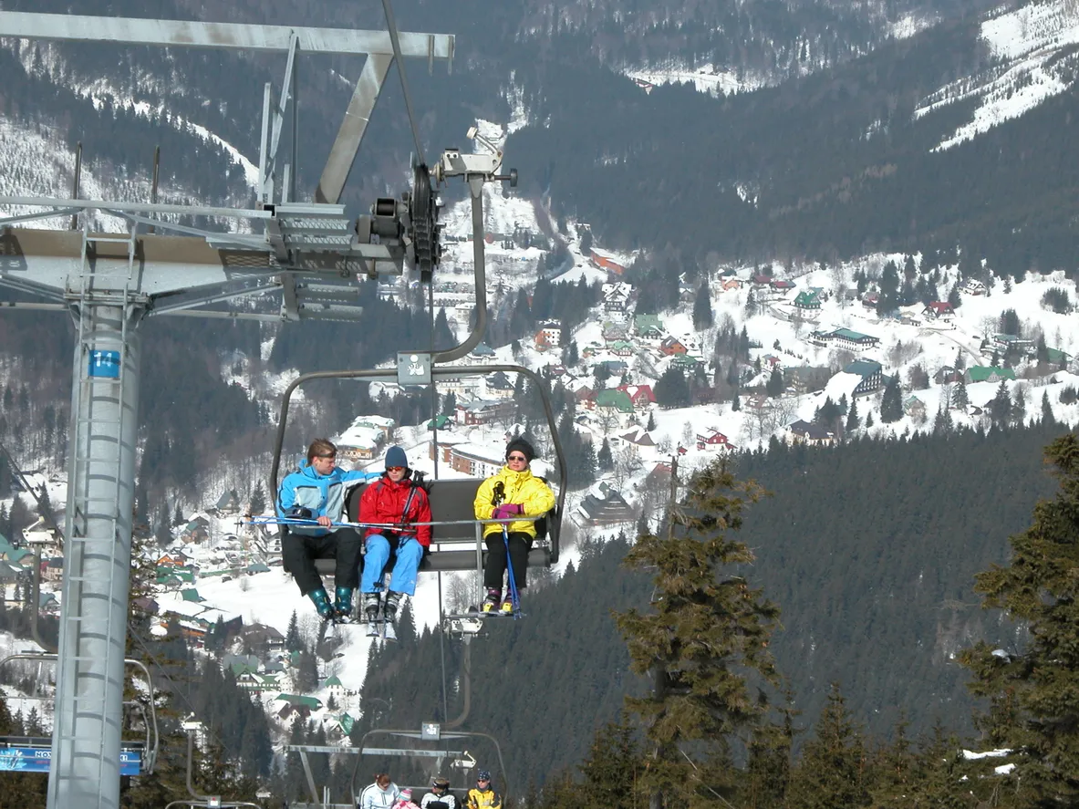 Spindleruv Mlyn, Czech Republic - March 24, 2006: Skiers riding a chair lift at a ski area.