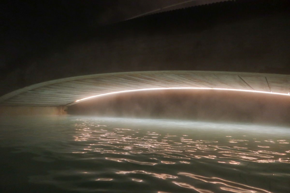 A bridge spanning over the warm waters of the blue lagoon in Iceland.