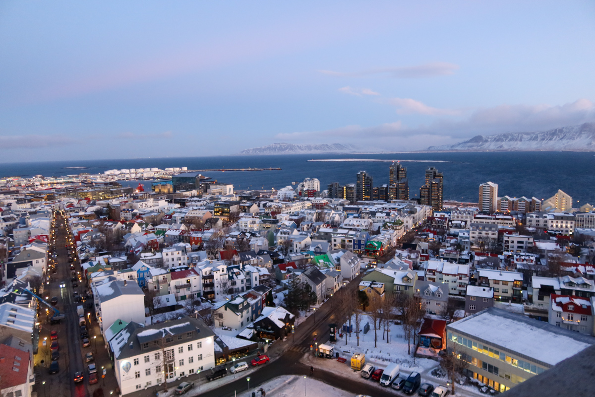 View of Reykjavik spreading out beneath you from the top of the Hallgrimskirkja, as the sun begins rising on a winter