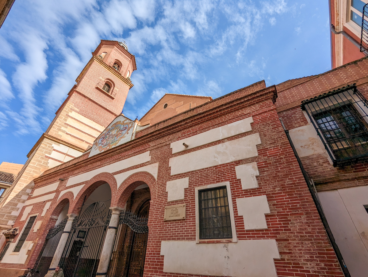 Church in Malaga with tower into the sky with a little cloud coverage.