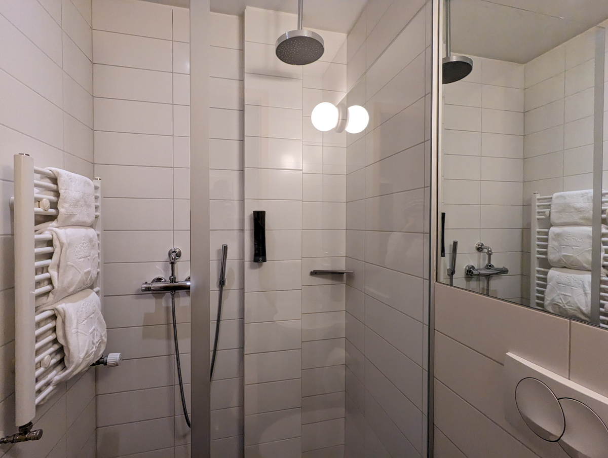 The bathroom at Reykjavik Lights by Kea Hotel, with rain showers and modern features.