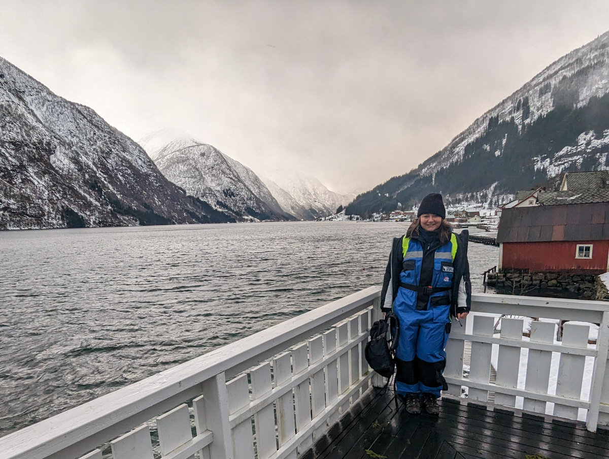 Girl standing by the fjord in Fjaerland