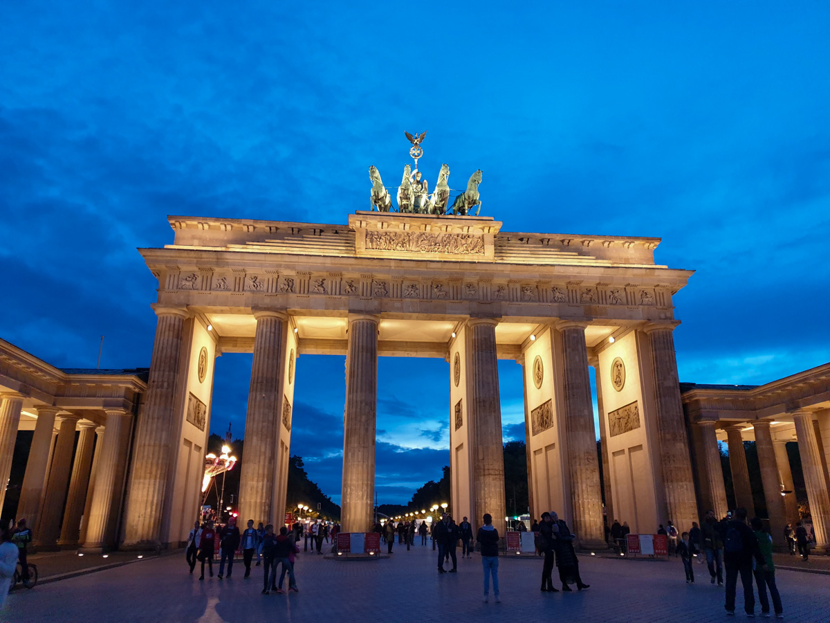 Few tourist crowds at Brandenburg Gate in Berlin at dusk.
