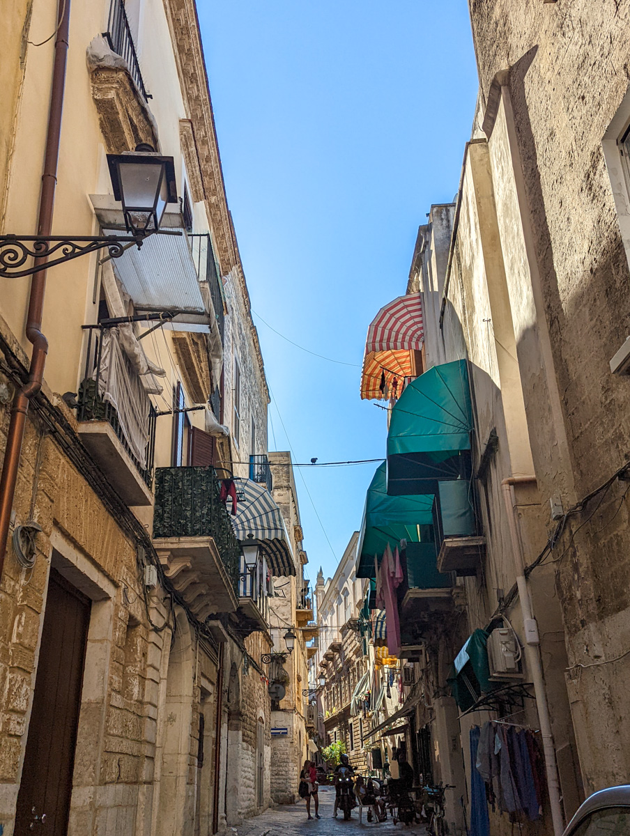 Bari old town, cobbled alleyways with buildings high on either side. 